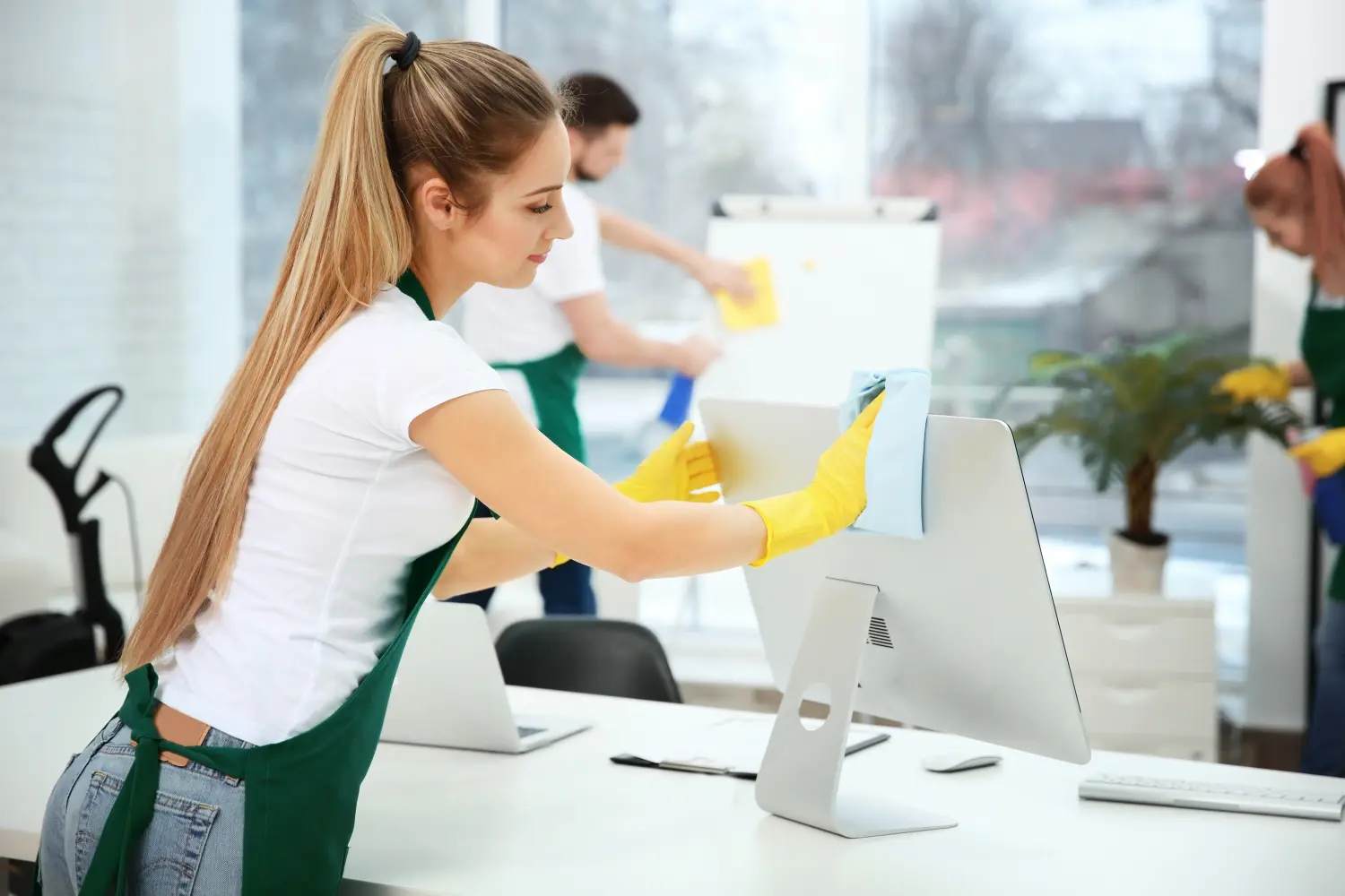 Junge Arbeiterin putzt Büro